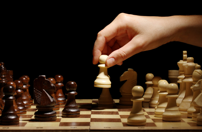 Chess board with chess pieces isolated on black