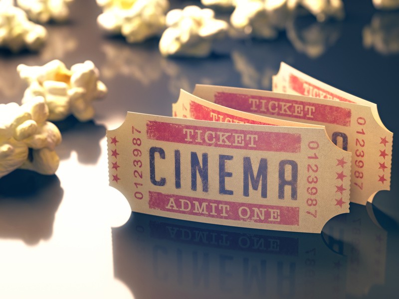 Entry ticket to the cinema with popcorn around.